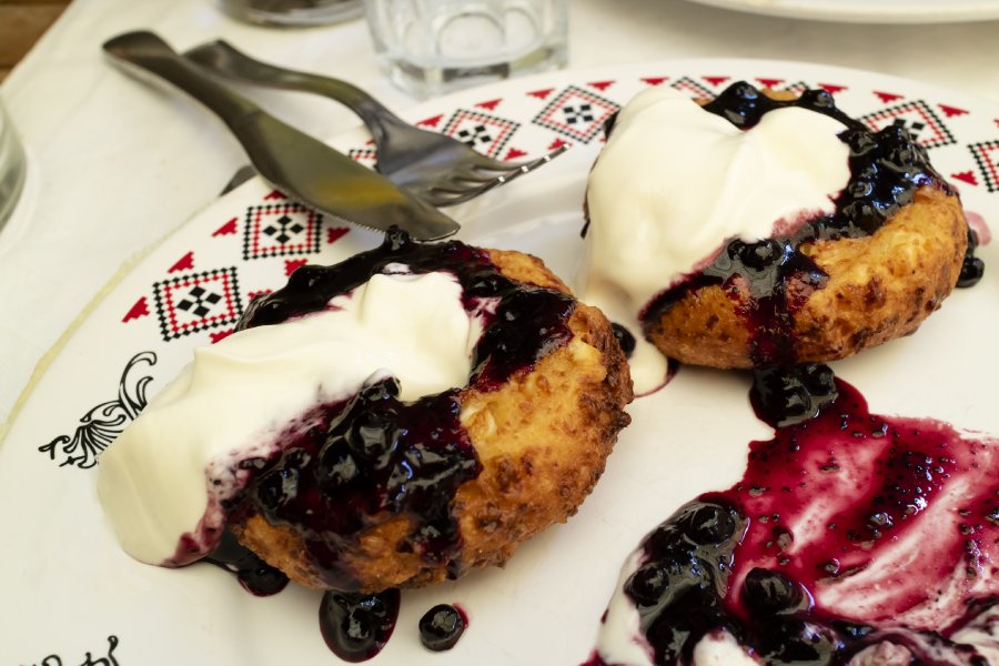 Papanasi or Chesse doughnuts - Romania's most famous dessert. Papanasi are like cheese doughnuts topped with jam