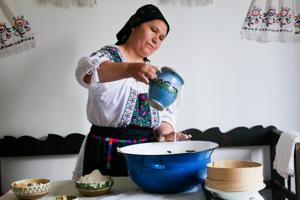 A romanian woman wearing national port cook with milk - one of our traditional drink.