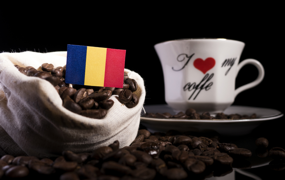 Coffee is a romanian traditional drink. This picture contain a cup of coffee and coffee beans